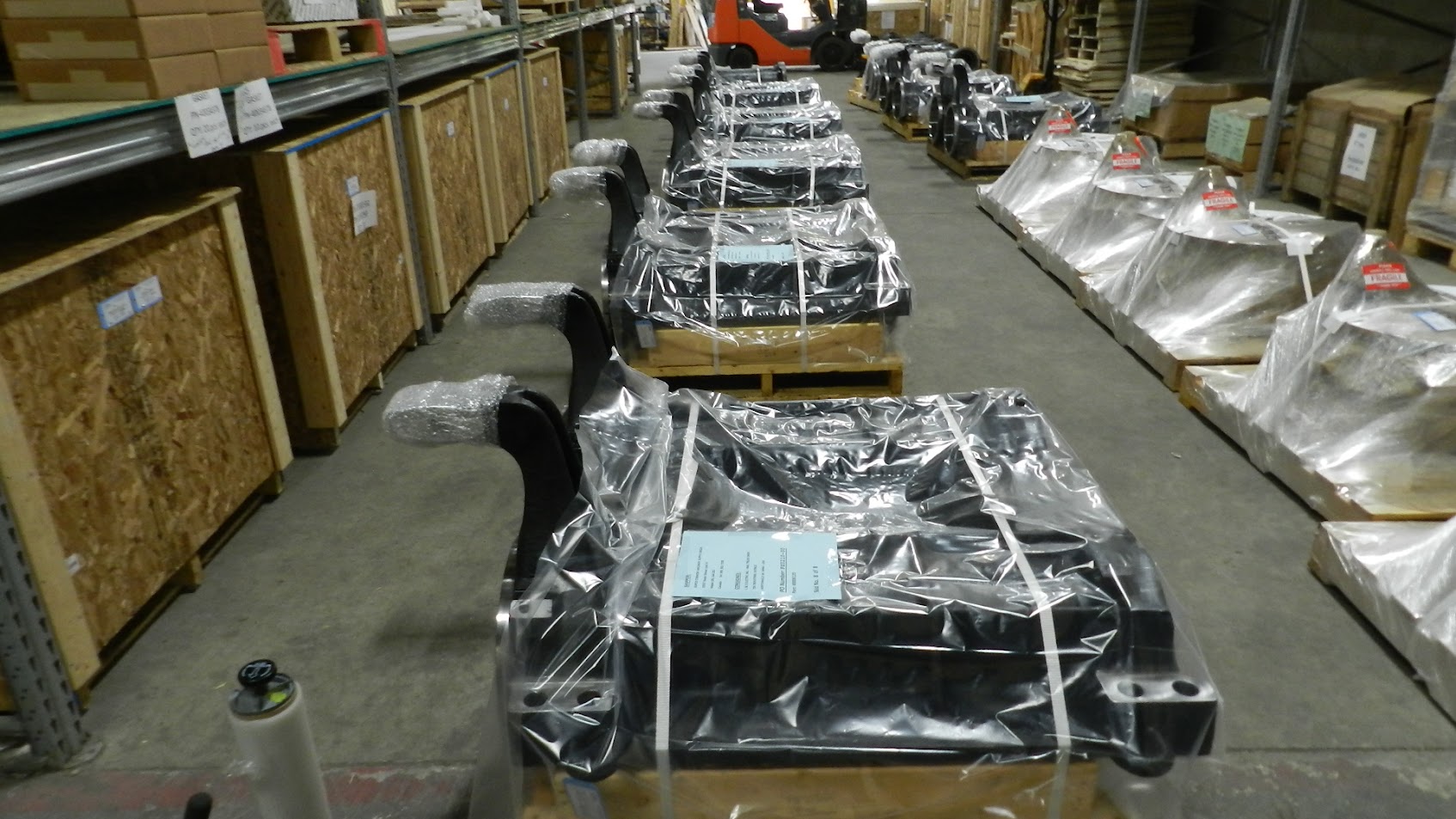 Wrapped locomotive components staged at shipping dock for dispatch